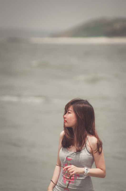 woman standing near body of water