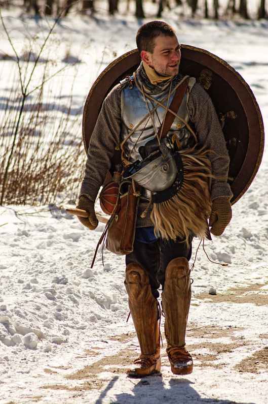 man wearing armor and walking in snowy field