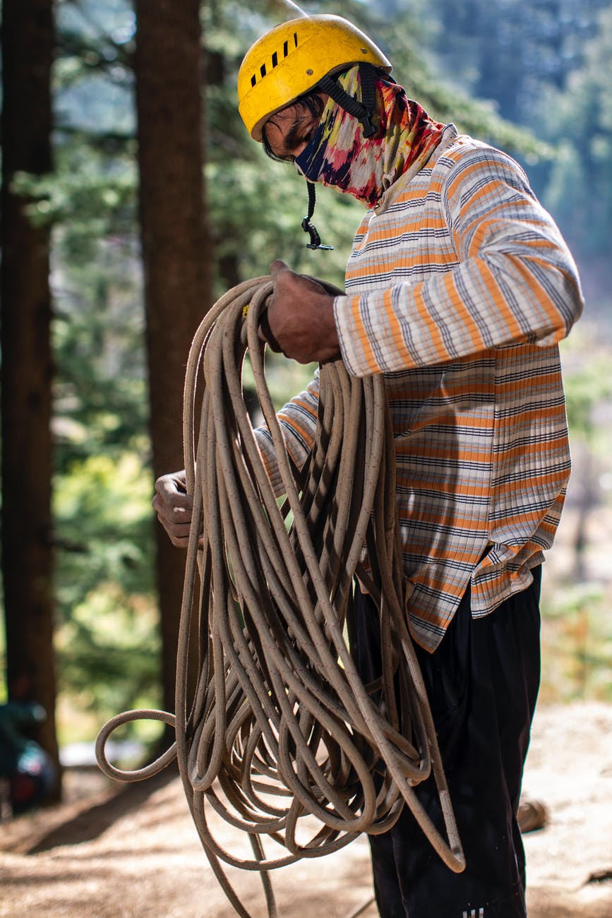 photo of man holding rope