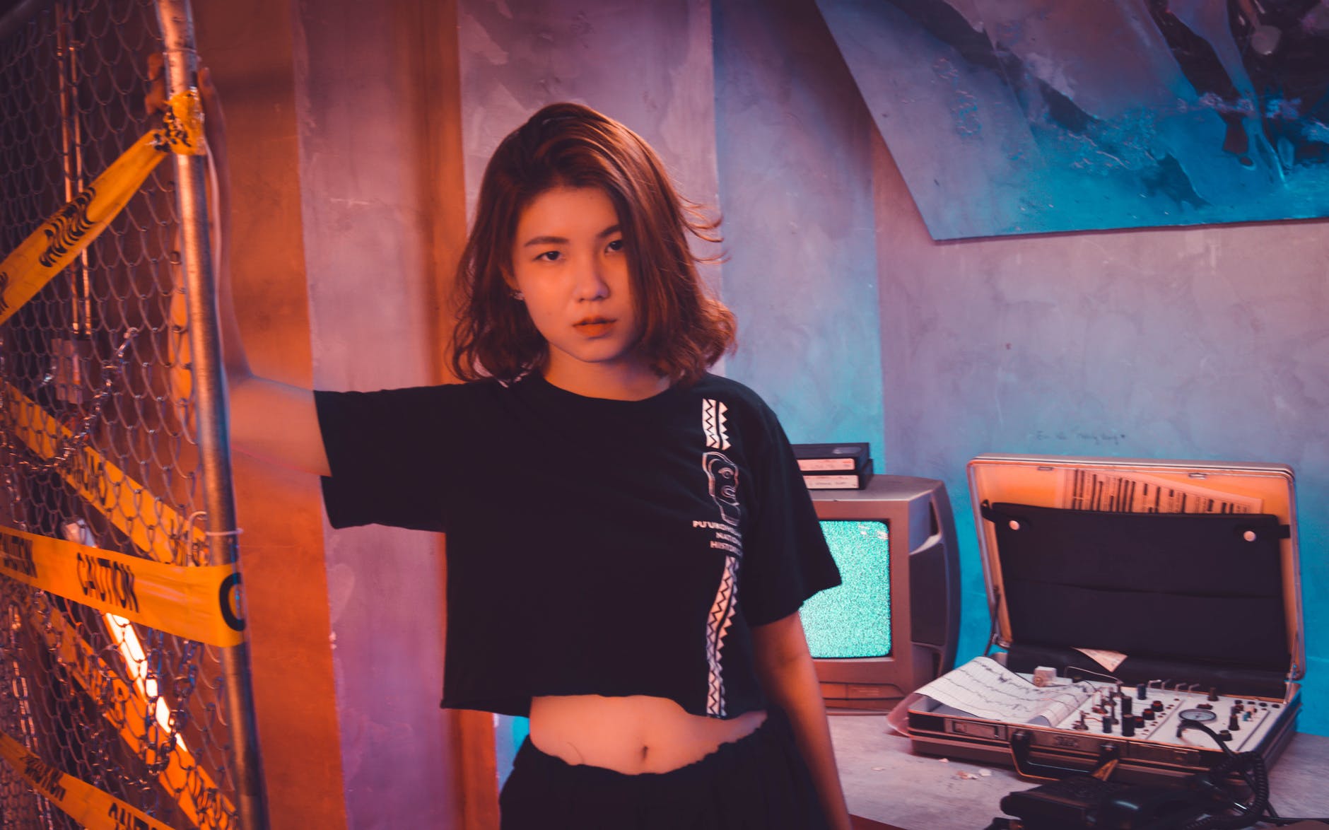 woman wearing crop top standing near wire fence