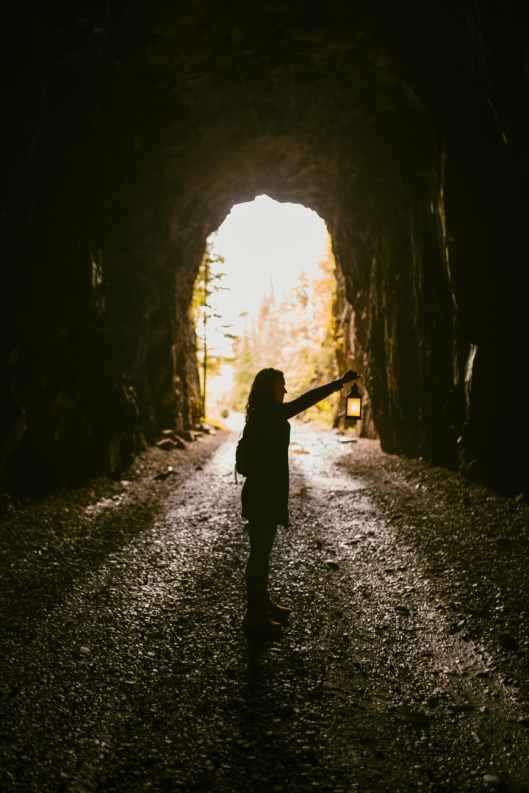 woman standing inside cave