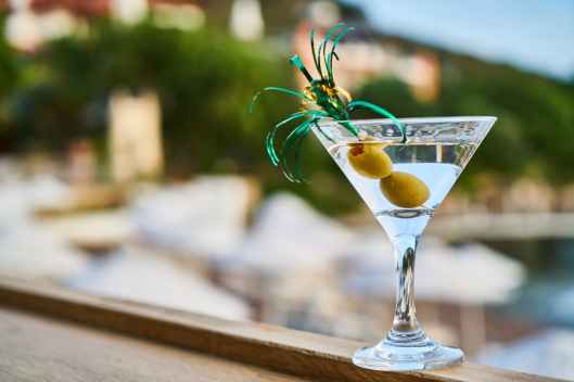 close up photo of martini with olives